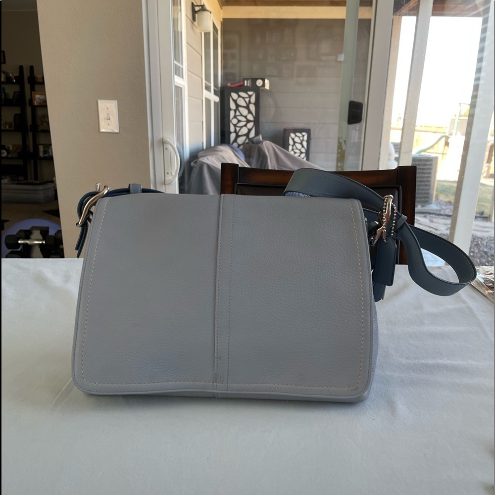 Coach in light blue over the shoulder purse.